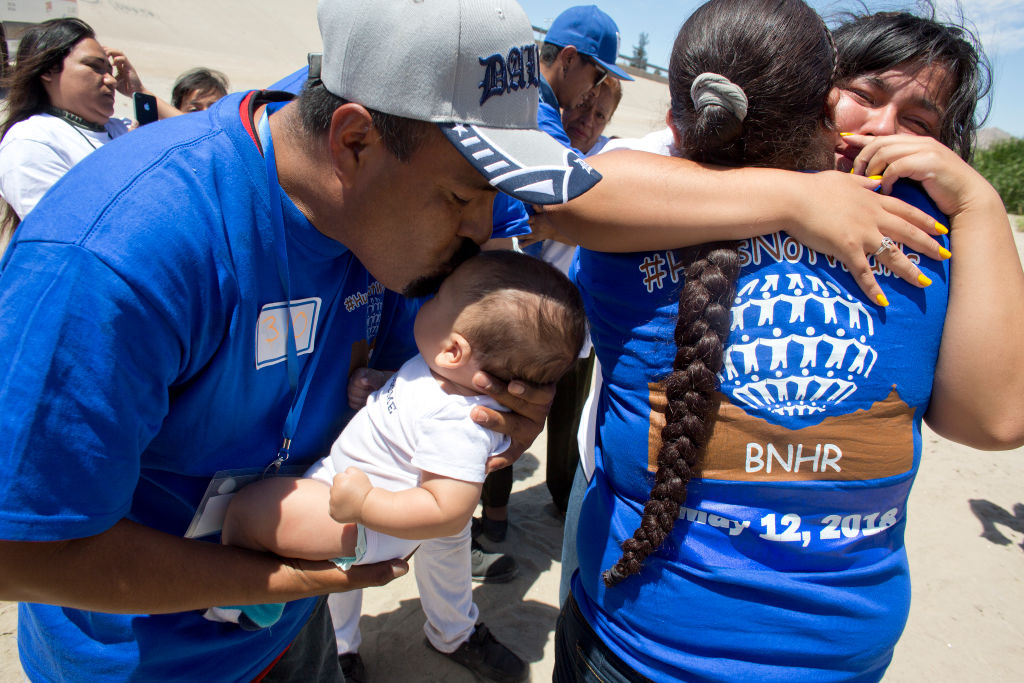 Latino families reuniting-hugging and kissing