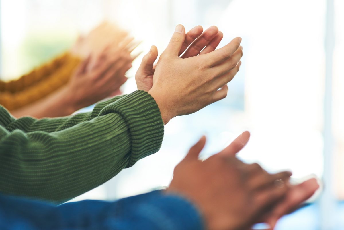 Closeup shot of a diverse group of people applauding together