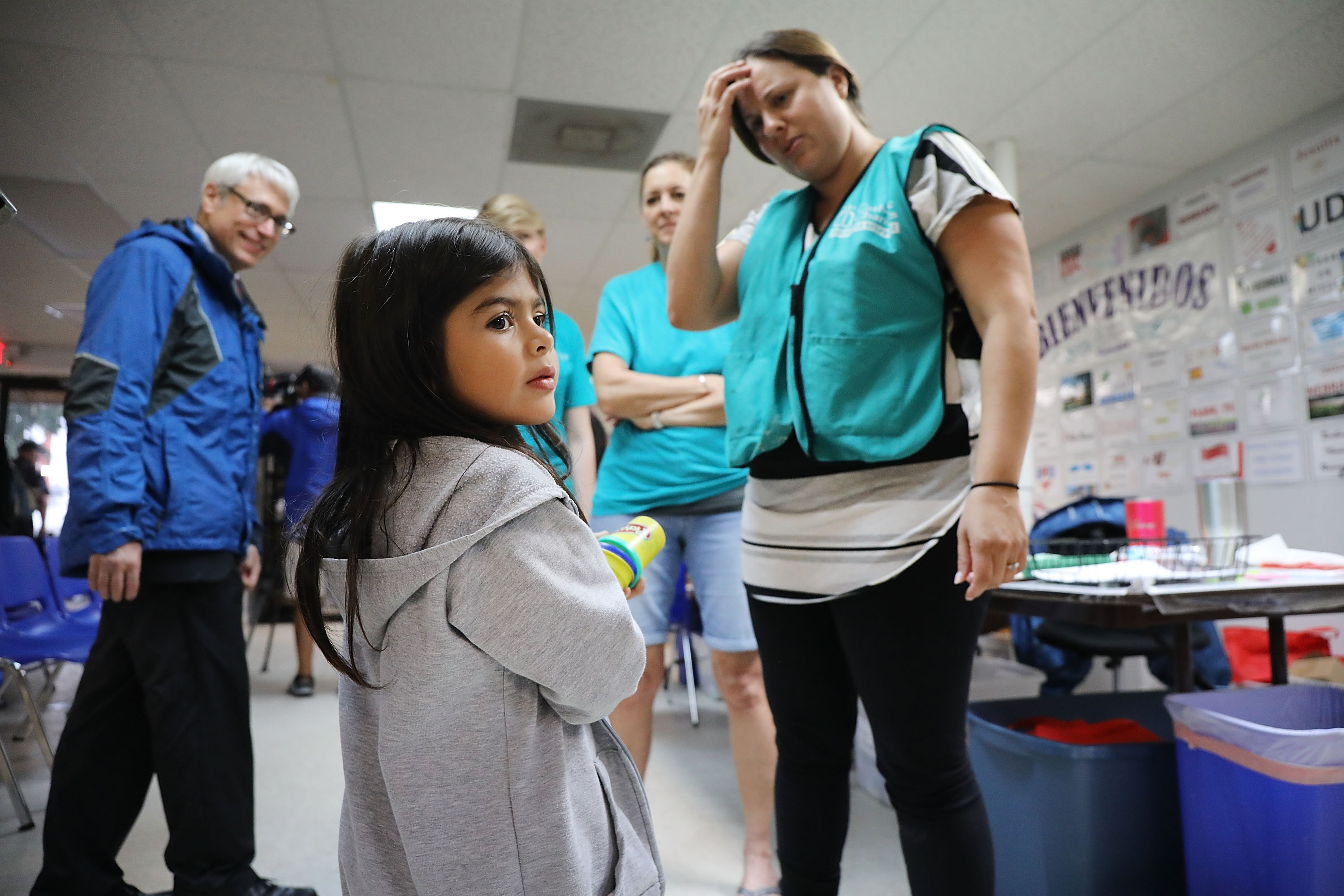 Jenquel, who crossed the U.S., Mexico border with her mother and siblings, speaks with volunteers at the Catholic Charities Humanitarian Respite Center in McAllen, Texas.(Spencer Platt/Getty Images)