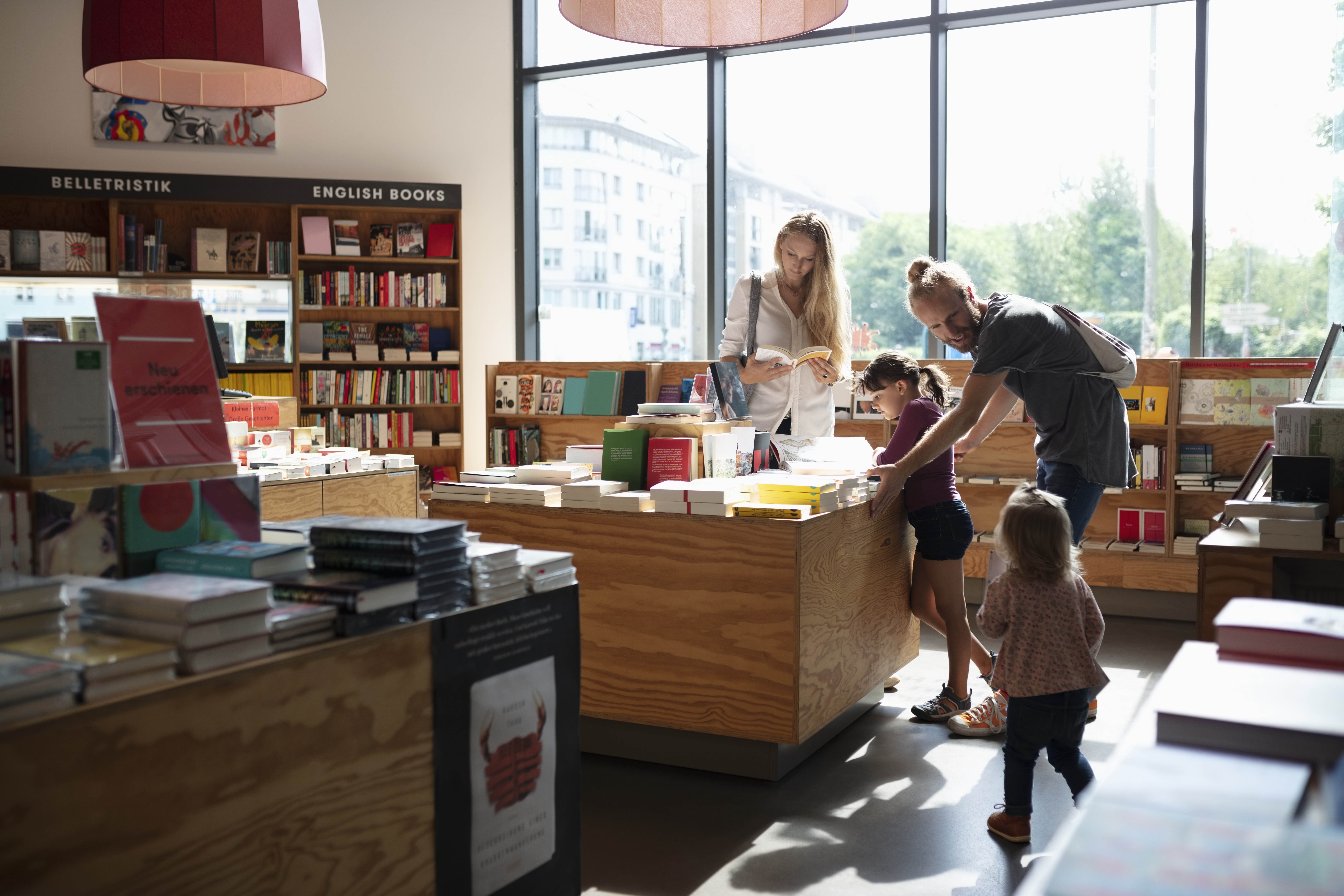 White family in bookstore looking at books: man woman and two children