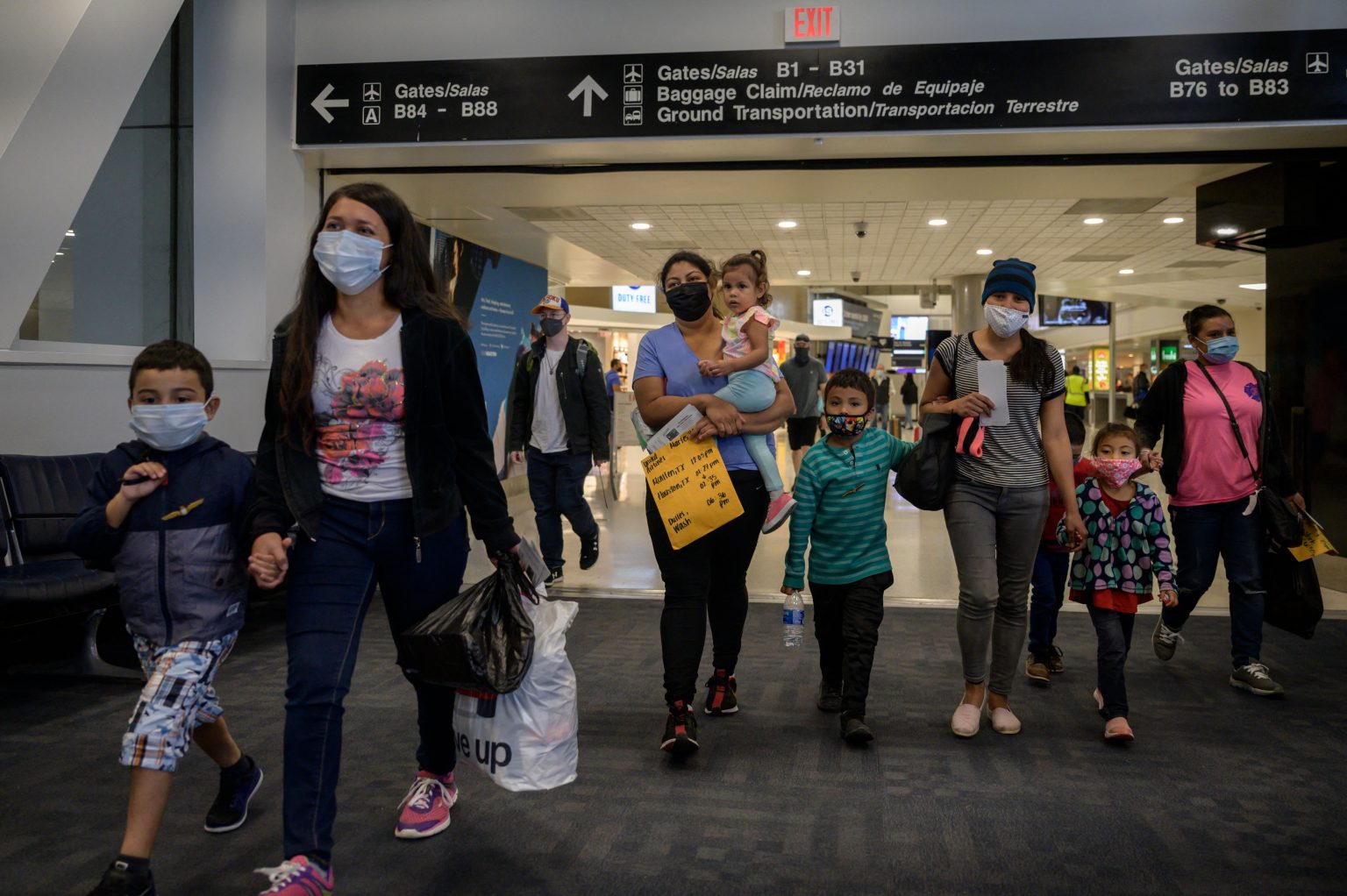 Parent and child Asylum seekers arrive in the US. at an airport