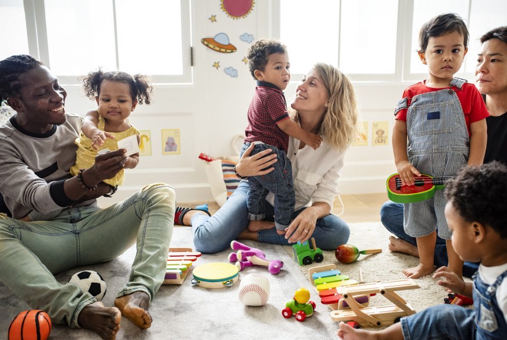Diverse children and adults enjoying playing with toys