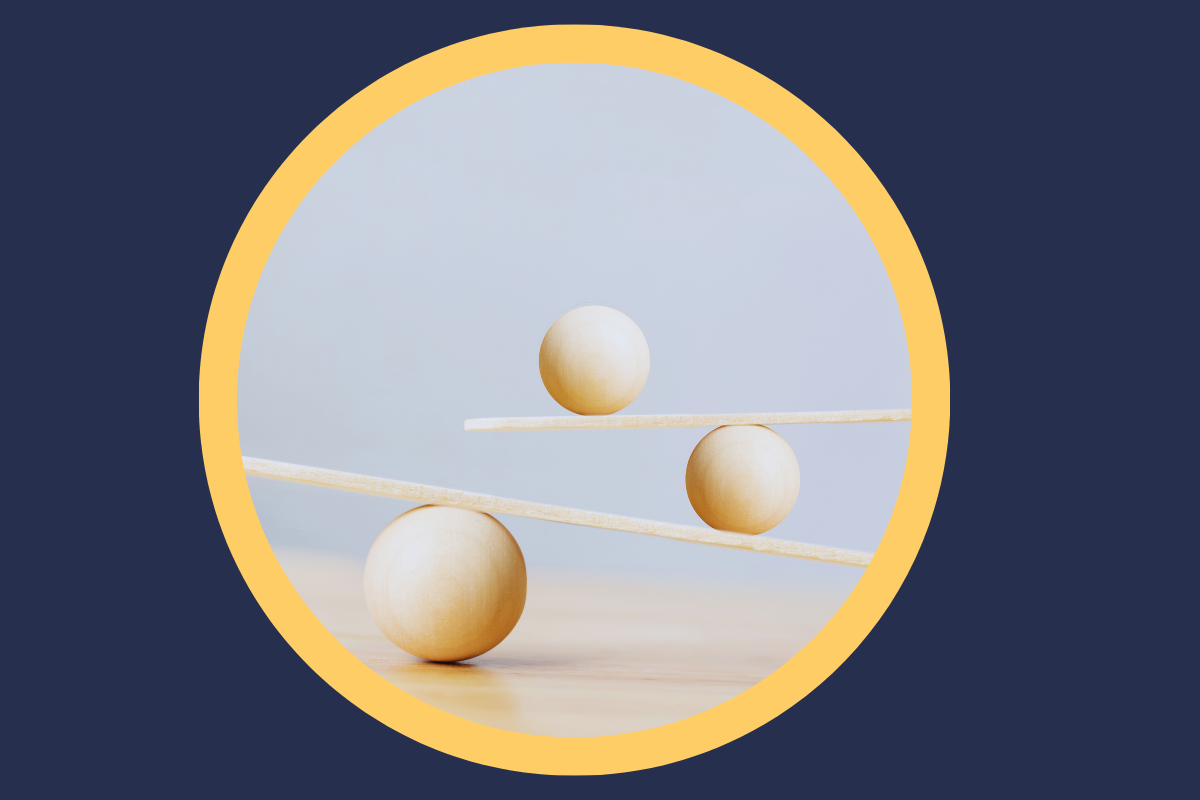 wooden balls balanced on flat pieces of wood within yellow circle on dark blue background