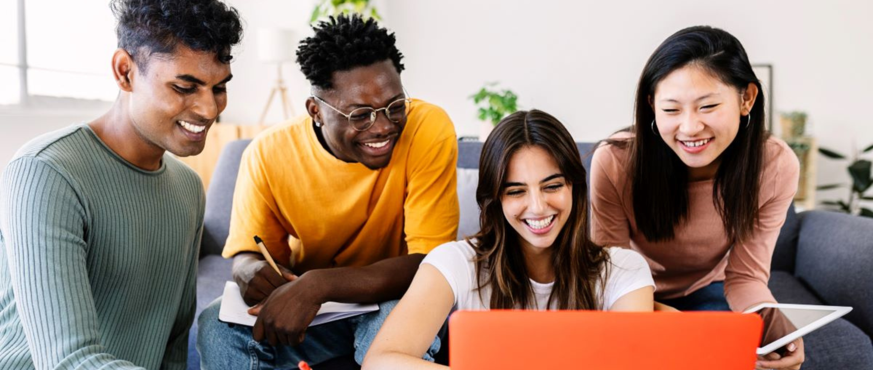 Young group of student friends studying together with computer at home