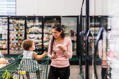 Happy mother and child shopping for groceries at supermarket