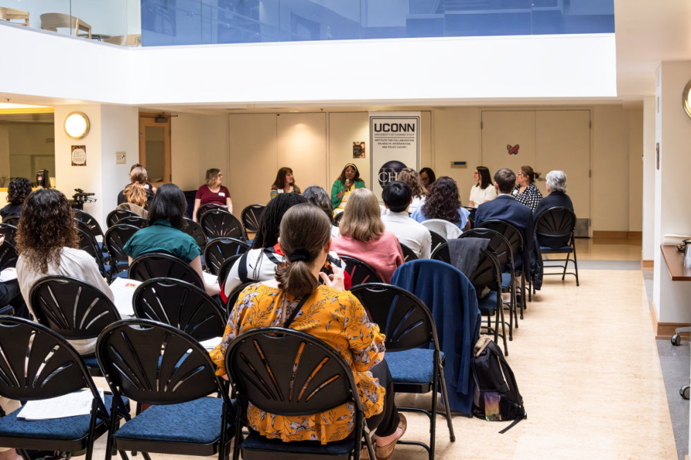 Kristen Cooksey Stowers, assistant professor in the Department of Allied Health Sciences, speaks during InCHIP's Community Engagement Research Core's May networking event.(Danielle Faipler/UConn Photo) 