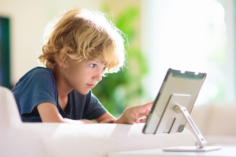 Young Child watching a video on a tablet FamVeld via Shutterstock