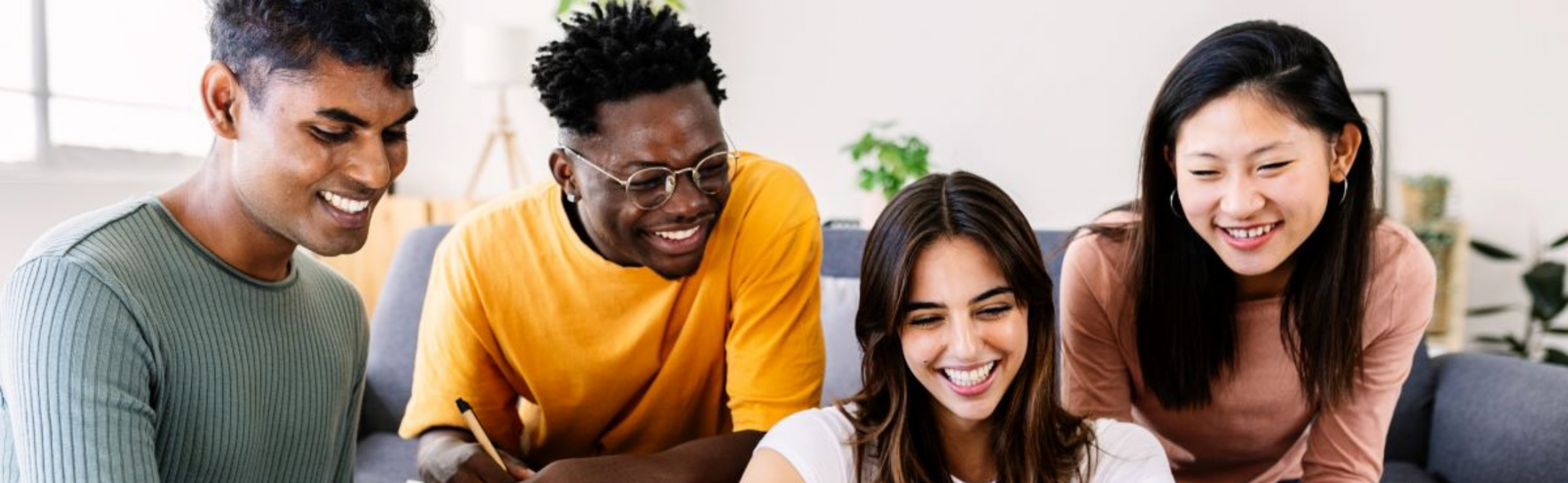 Young group of student friends studying together with computer at home